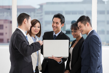 business team working together around a laptop