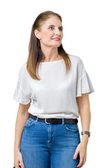Obraz premium Middle age mature beautiful woman over isolated background looking away to side with smile on face, natural expression. Laughing confident.