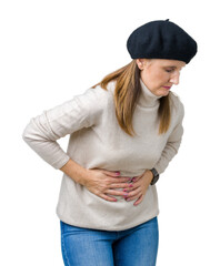 Middle age mature woman wearing winter sweater and beret over isolated background with hand on stomach because indigestion, painful illness feeling unwell. Ache concept.