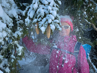 nice and active senior woman snowshoeing in deep powder snow in the Allgau alps, Bavaria, 