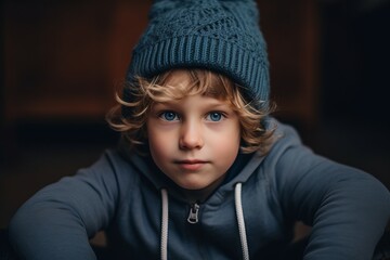 Portrait of a cute little boy in a blue knitted hat