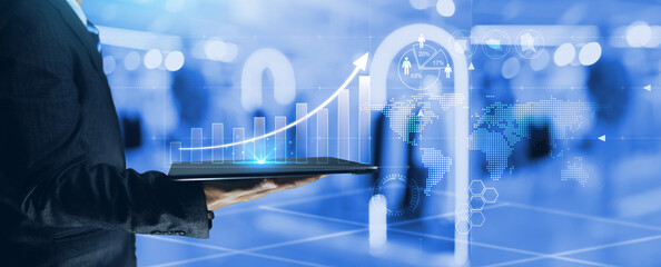 Growth business graph concept with businessman holding tablet and chart display on screen in rise...