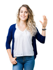 Beautiful young blonde woman over isolated background showing and pointing up with fingers number five while smiling confident and happy.