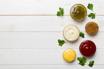 Many different sauces and herbs on table, flat lay top view. sauces with spices healthy concept