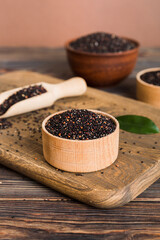 quinoa seeds in bowl and spoon on colored background. Healthy kinwa in small bowl. Healthy superfood