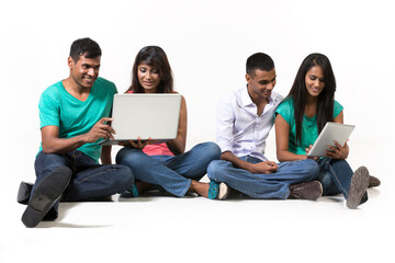 Group of Indian friends using modern technology.