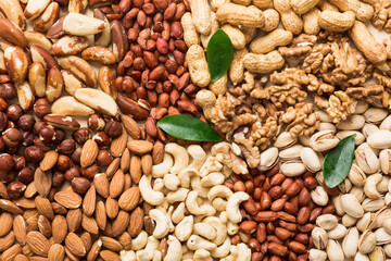 different nuts frame background. Close up, top view, flat lay with vopy space. Walnut, pistachios, almonds, hazelnuts and cashews