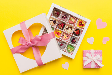 Valentine day composition: sweet candy, with gift boxes with bow and red felt hearts, photo template, background. Top View with copy space