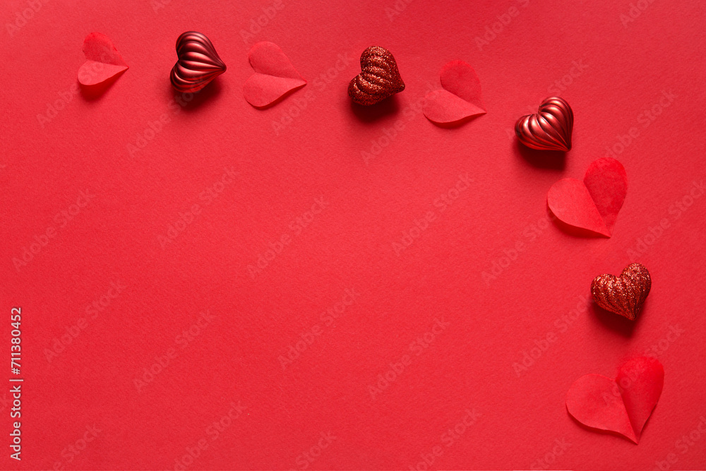 Wall mural Valentines day card mockup with red hearts on red paper background, top view, copy space.	