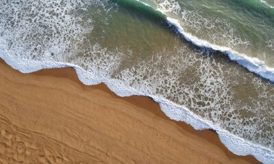 Aerial View of Foamy Ocean Waves Meeting Sandy Shore