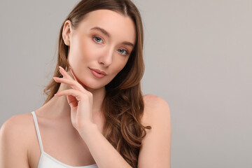 Fototapeta premium Beautiful woman with healthy skin on gray background, space for text