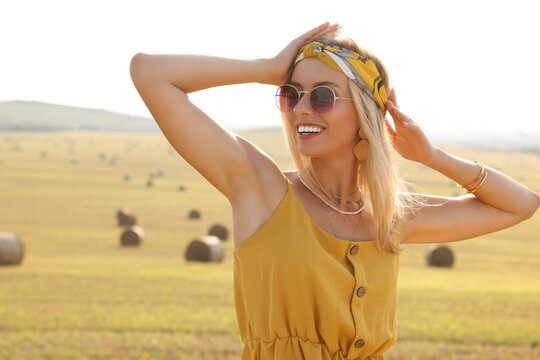 Portrait of beautiful happy hippie woman in field