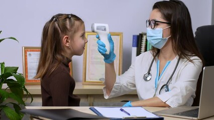 Doctor measures the girl patient temperature - Powered by Adobe