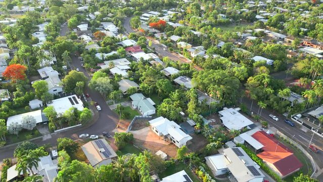 Enervated tropical designed home in green leafy suburb aerial drone. Family friendly suburb with parks shops and schools surrounding