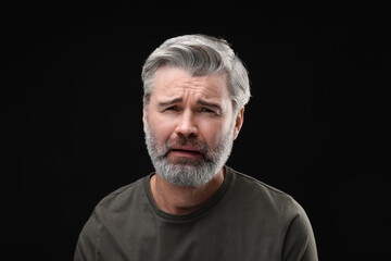 Obraz premium Personality concept. Portrait of emotional man on black background