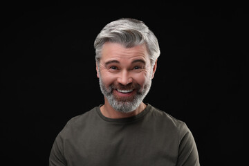 Personality concept. Portrait of happy man on black background