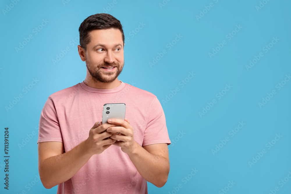 Poster man sending message via smartphone on light blue background, space for text