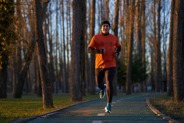 Man running in the park in wintertime
