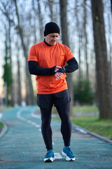 Mature jogger starting up his smartwatch