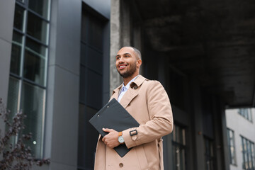 Happy man with clipboard outdoors. Lawyer, businessman, accountant or manager