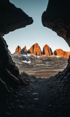 Majestic Mountain Peaks Viewed From Dark Cave Opening