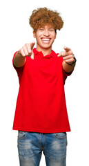 Young handsome man with afro hair wearing red t-shirt Pointing to you and the camera with fingers, smiling positive and cheerful