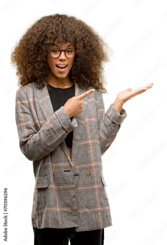 Wall mural african american woman wearing a jacket very happy pointing with hand and finger