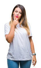 Fototapeta premium Young beautiful woman casual white t-shirt over isolated background looking confident at the camera with smile with crossed arms and hand raised on chin. Thinking positive.