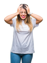 Obraz na płótnie Canvas Young beautiful woman casual white t-shirt over isolated background suffering from headache desperate and stressed because pain and migraine. Hands on head.