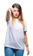 Fototapeta premium Young beautiful woman casual white t-shirt over isolated background looking unhappy and angry showing rejection and negative with thumbs down gesture. Bad expression.
