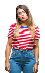 Young beautiful woman casual look over isolated background with serious expression on face. Simple and natural looking at the camera.