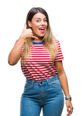 Young beautiful woman casual look over isolated background smiling doing phone gesture with hand and fingers like talking on the telephone. Communicating concepts.