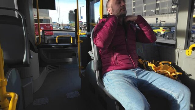 Commuter inside a bus at city station.