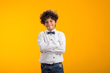 Obraz na płótnie Canvas Smiling happy boy 6-7 years old. On yellow background studio