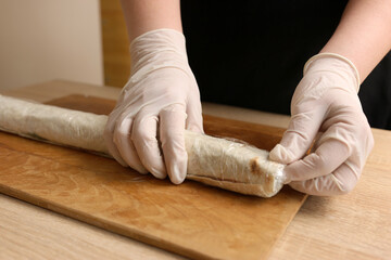 For storage, the pita roll is wrapped in cling film
