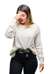 Young beautiful woman casual white sweater over isolated background tired rubbing nose and eyes feeling fatigue and headache. Stress and frustration concept.