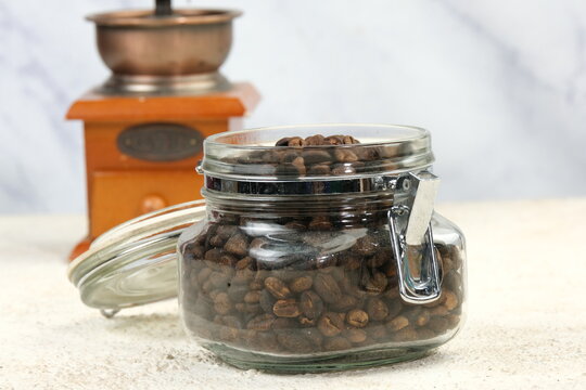 coffee beans in a jar and coffee grinder 