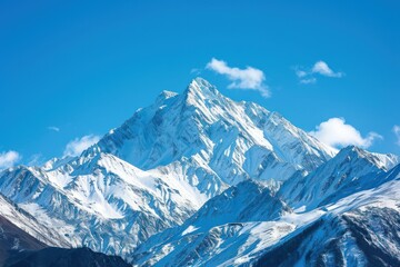 Obraz premium Capture the grandeur of snow-capped peaks against a clear blue sky