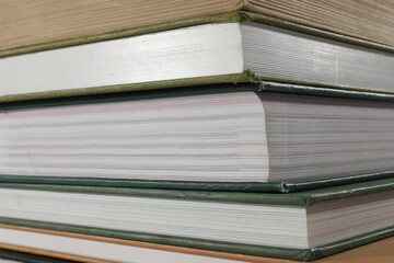 Stack of many different hardcover books as background, closeup