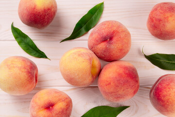 Fresh peaches on a wooden table.