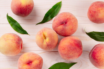 Fresh peaches on a wooden table.