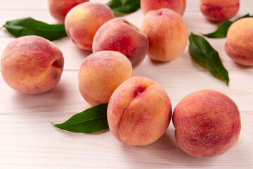 Fresh peaches on a wooden table. Summer peach fruit background.