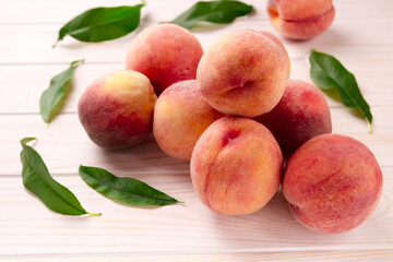 Fresh peaches on a wooden table. Summer peach fruit background.