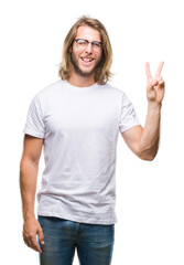 Young handsome man with long hair wearing glasses over isolated background smiling with happy face...