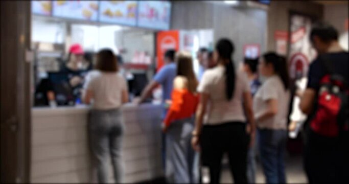 A Group of People Waiting in Line at a Fast Food Restaurant. Blurred background 4K video