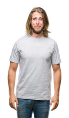 Young handsome man with long hair over isolated background depressed and worry for distress, crying angry and afraid. Sad expression.