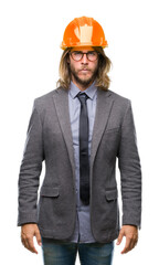 Young handsome architec man with long hair wearing safety helmet over isolated background skeptic and nervous, frowning upset because of problem. Negative person.