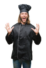 Young handsome cook man with long hair over isolated background celebrating mad and crazy for success with arms raised and closed eyes screaming excited. Winner concept