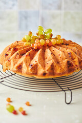 Delicious homemade grape sponge cake with noble mold cheese on a stone background.