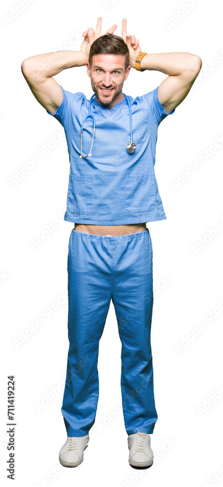 Poster handsome doctor man wearing medical uniform over isolated background posing funny and crazy with fin